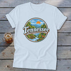 White t-shirt with circular graphic of Tennessee landscape, deer, and river.