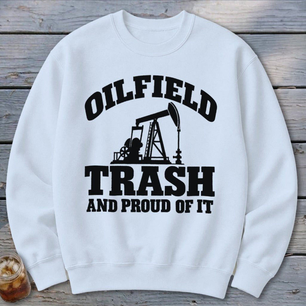 White sweatshirt with black text and oil pump graphic reading "Oilfield Trash and Proud of It".