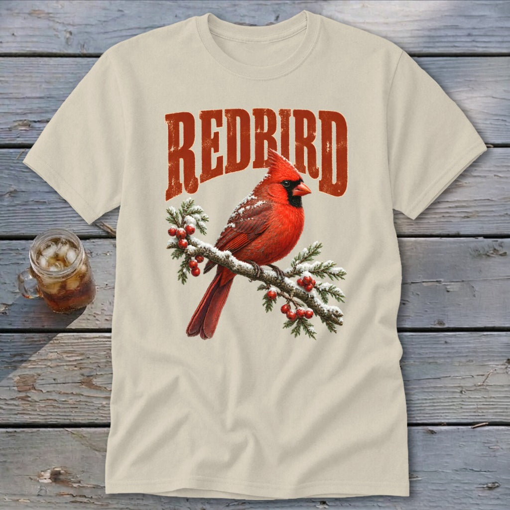 Cream t-shirt featuring a graphic of a red cardinal on a snowy branch with "REDBIRD" text.
