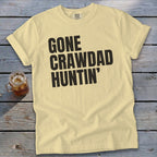Light yellow t-shirt with "GONE CRAWDAD HUNTIN'" text and a drink.