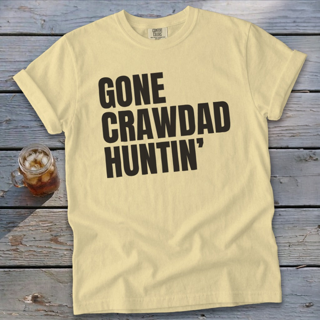 Light yellow t-shirt with "GONE CRAWDAD HUNTIN'" text and a drink.