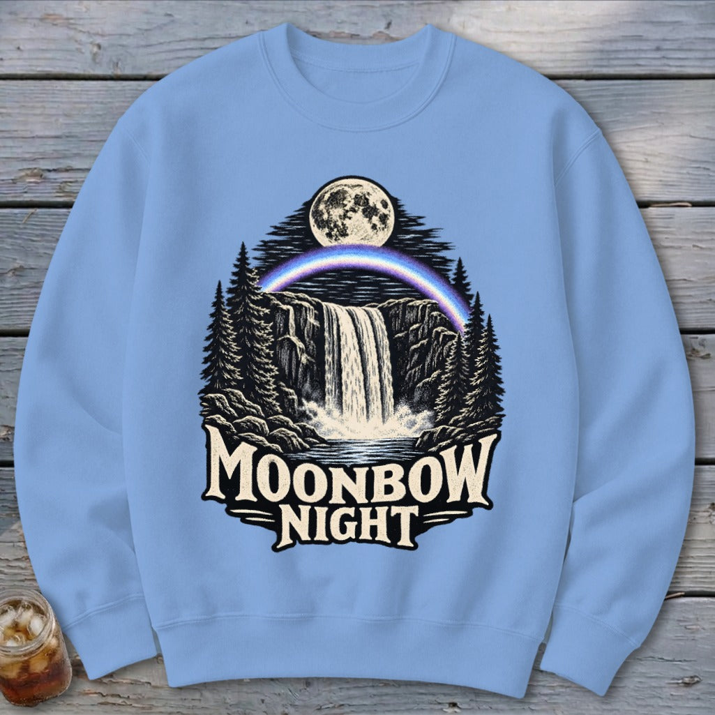 Light blue crewneck sweatshirt with a "Moonbow Night" graphic of a waterfall, moon, and rainbow.