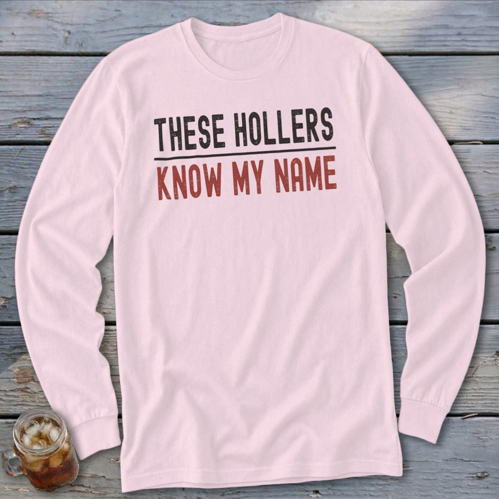 Pink long sleeve shirt with "THESE HOLLERS KNOW MY NAME" text.