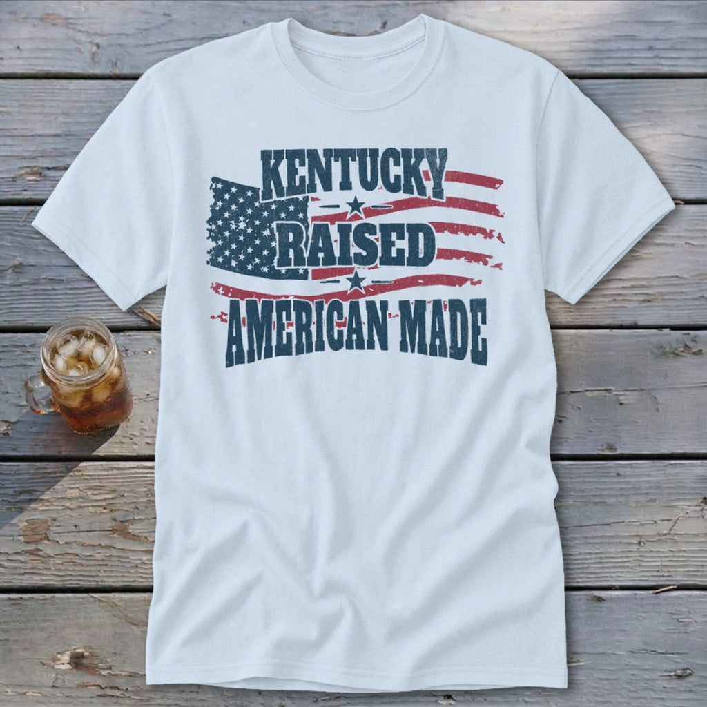 White t-shirt with "Kentucky Raised American Made" and distressed American flag graphic.