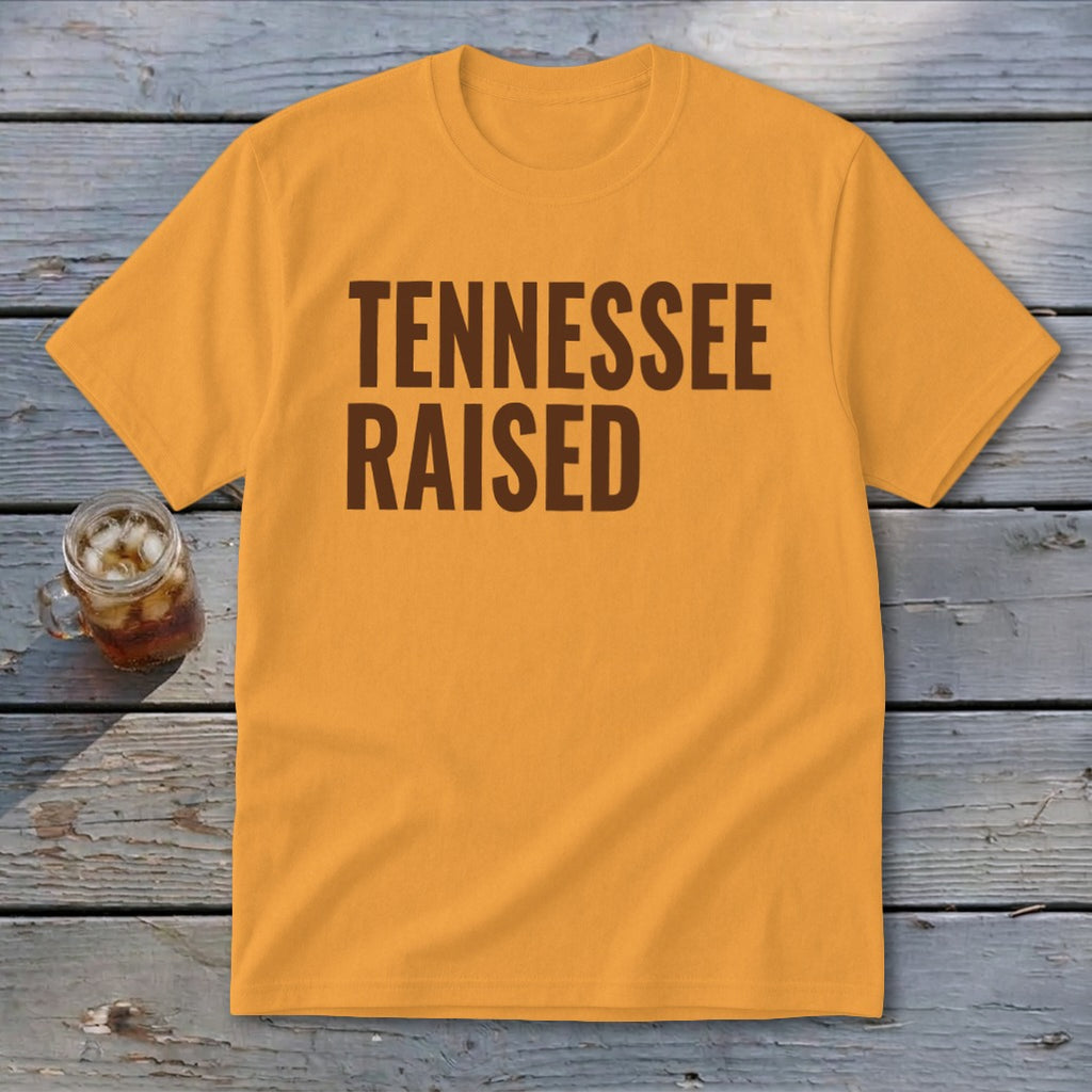 Orange t-shirt with brown text reading "TENNESSEE RAISED".