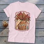 Sorghum graphic on pink t-shirt with wooden barrel and grain illustration.