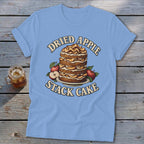Light blue t-shirt with "Dried Apple Stack Cake" graphic featuring a tall cake and apples.