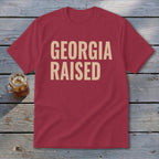 Red t-shirt with "GEORGIA RAISED" text and a glass of iced tea.