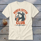 Cream t-shirt featuring a bear in a baseball cap drinking from a jar, with "Porch Sittin' Club est. after supper" text.