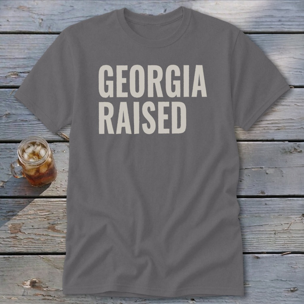 Grey t-shirt with white text reading "GEORGIA RAISED".