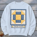 Light blue sweatshirt with a "Churn Dash" quilt block design and text.