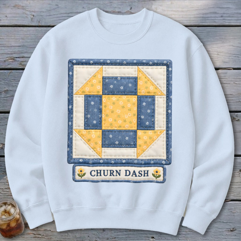 Light blue sweatshirt with a "Churn Dash" quilt block design and text.