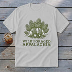 White t-shirt with green illustration of morel mushrooms and text "WILD FORAGED APPALACHIA".