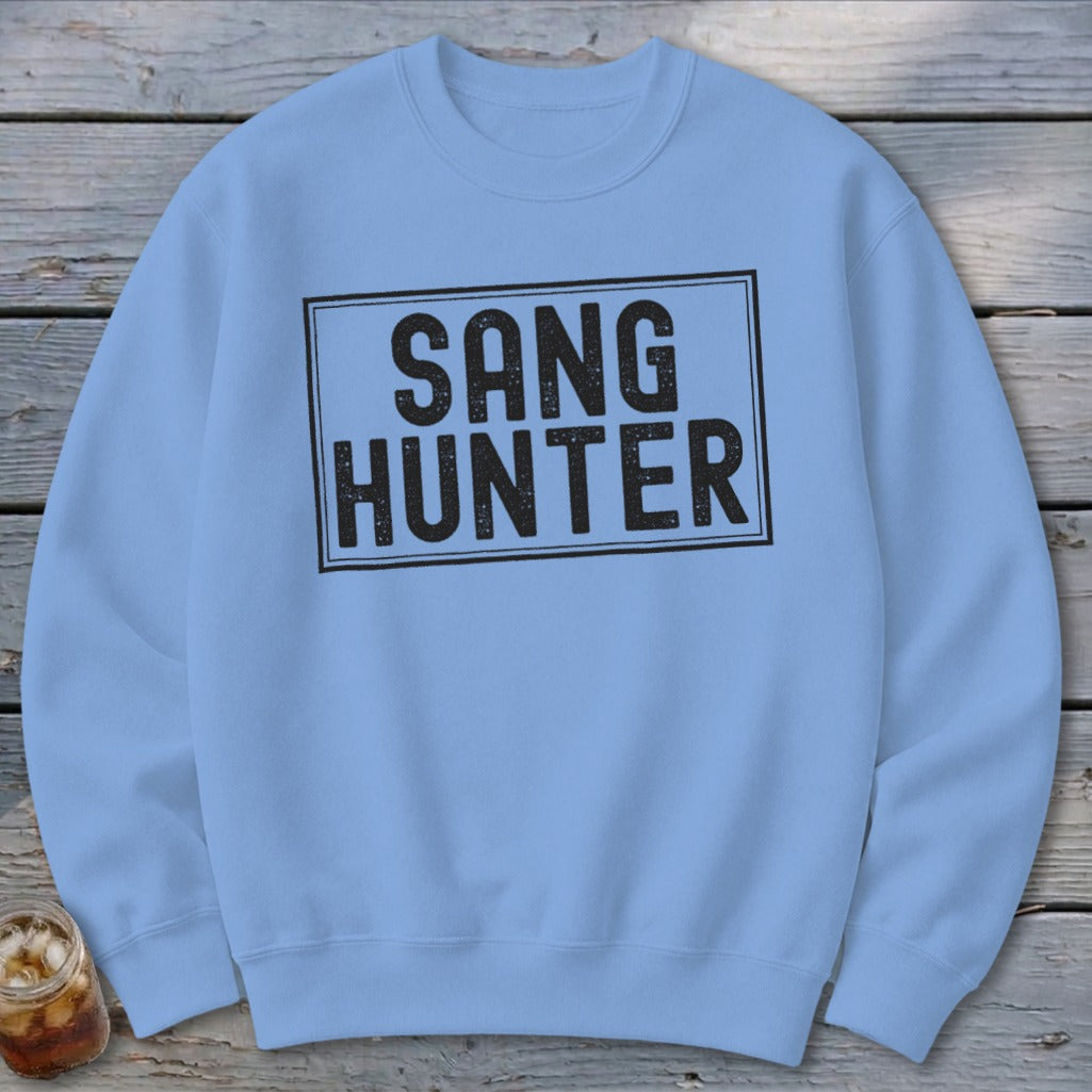 Light blue sweatshirt with black text that reads "SANG HUNTER" in a rectangle.