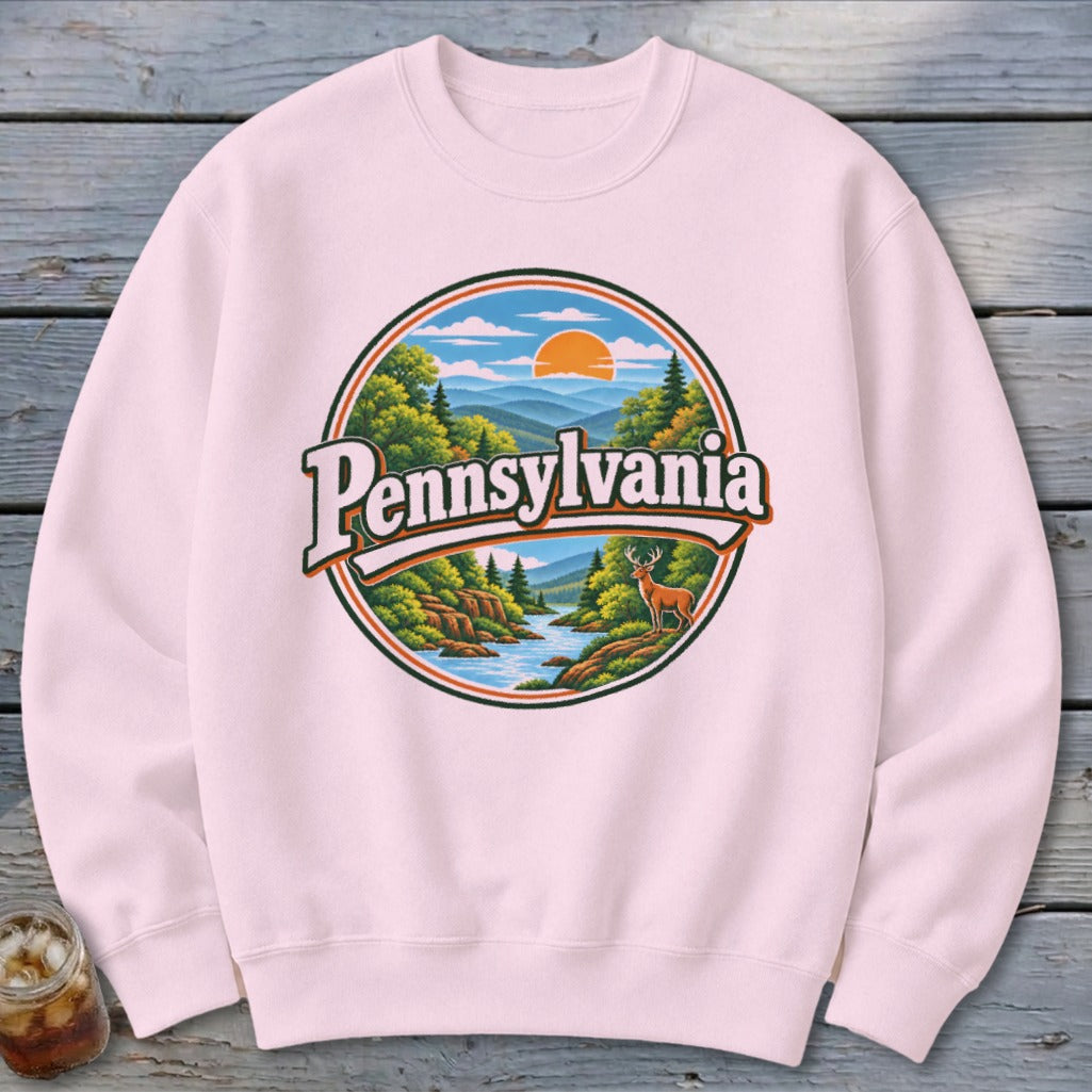 Pink sweatshirt with a circular graphic featuring "Pennsylvania" over a scenic landscape with a deer.