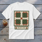 White t-shirt with a green and red "Bear's Paw" quilt block design and text.
