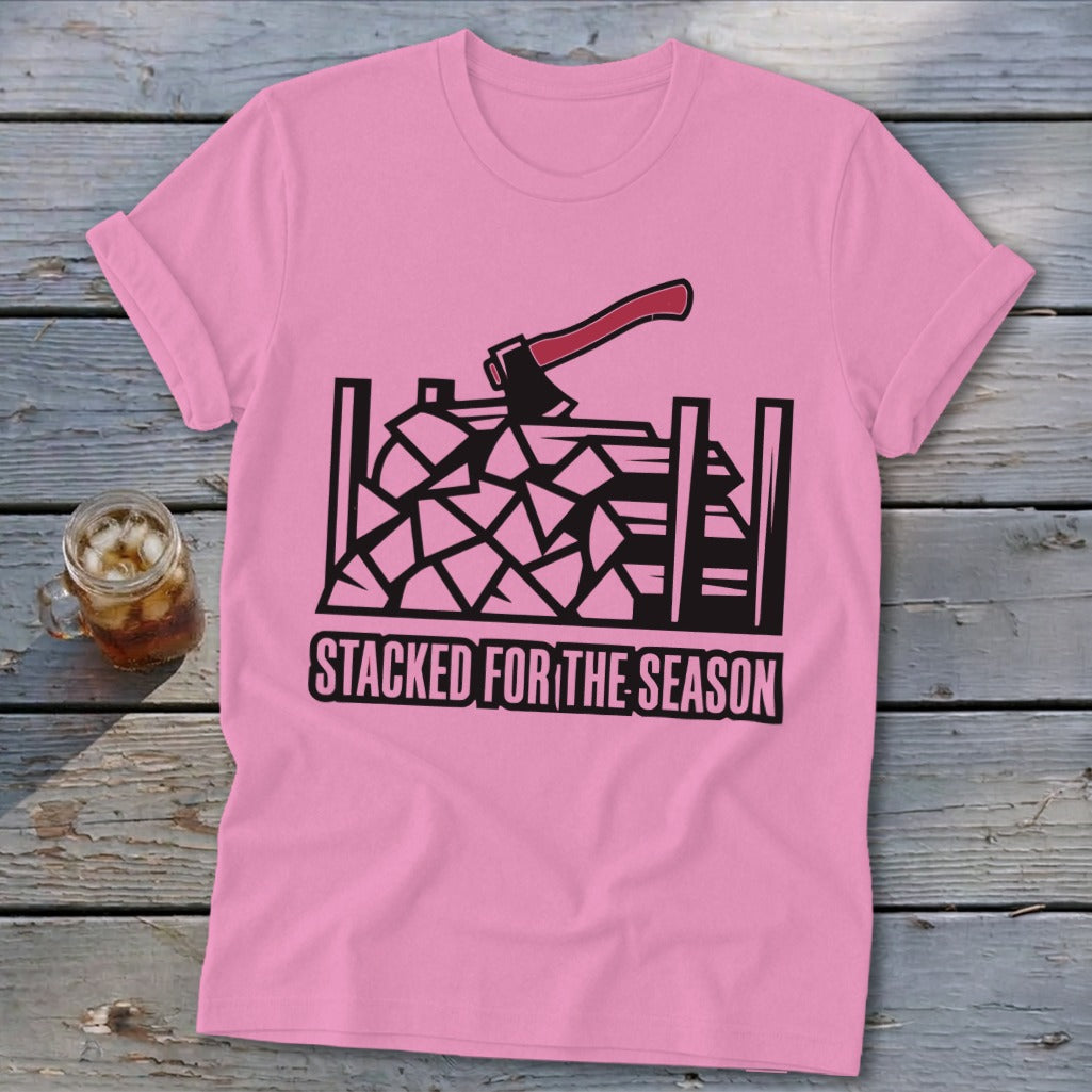 Pink t-shirt with graphic of axe and stacked firewood, text reads "Stacked for the Season".