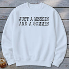 White sweatshirt with black text reading "JUST A MESSIN AND A GOMMIN".