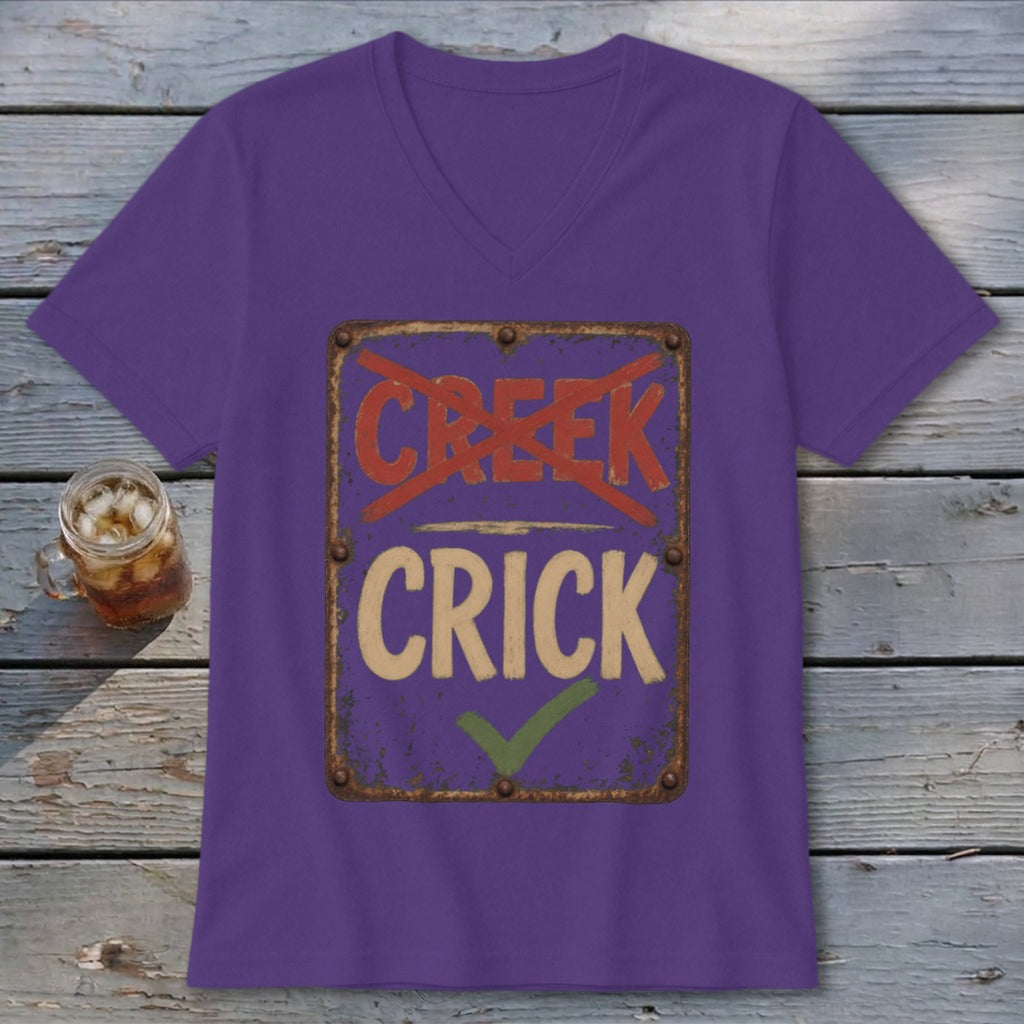 Purple V-neck t-shirt with a distressed sign that reads "CREEK" crossed out and "CRICK" checked.