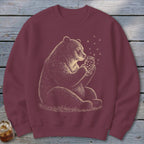 Maroon sweatshirt with illustration of bear holding jar of stars.