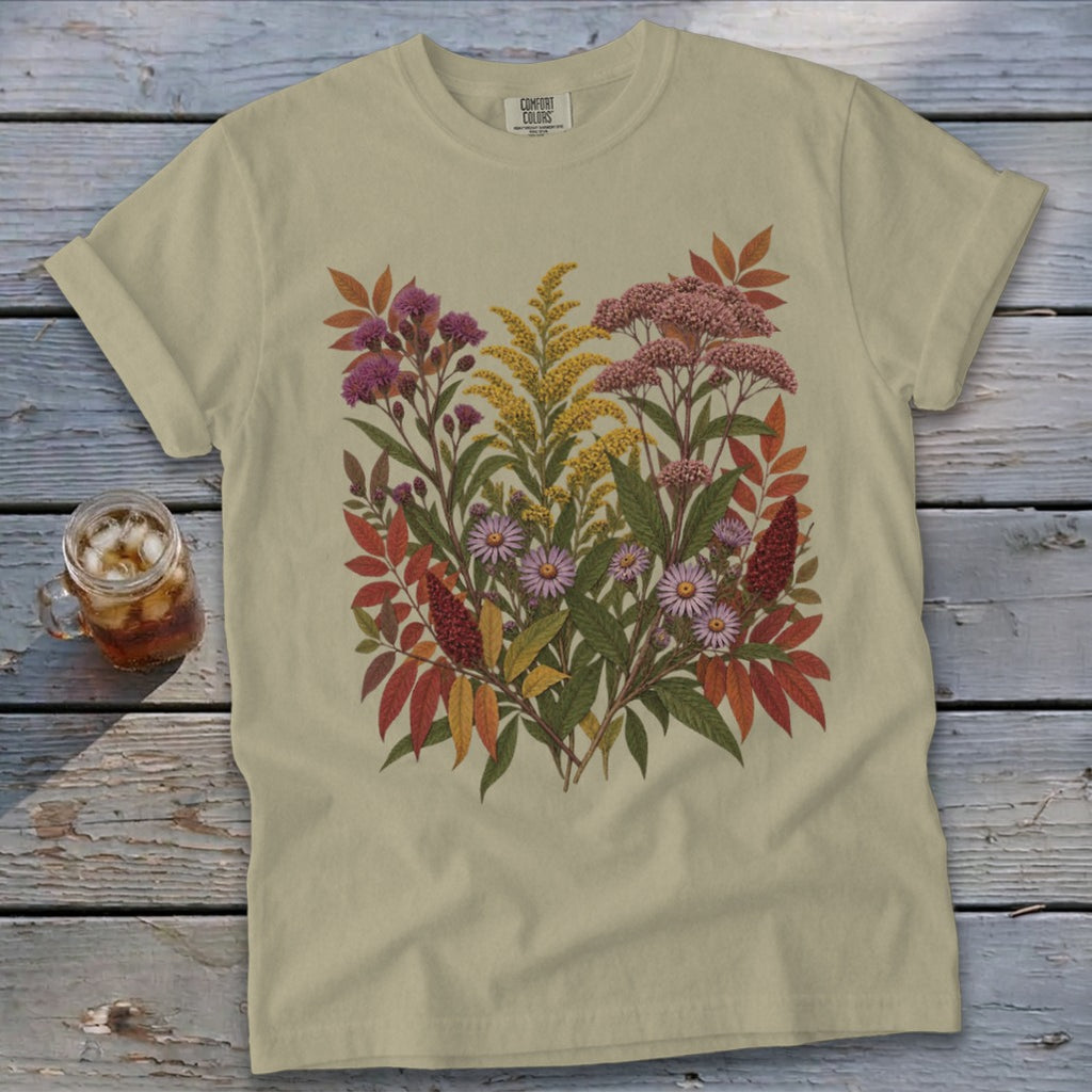 Light tan t-shirt with a colorful botanical print featuring autumn flowers and leaves.