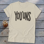 Light-colored t-shirt with "YOU'UNS" printed in dark text.