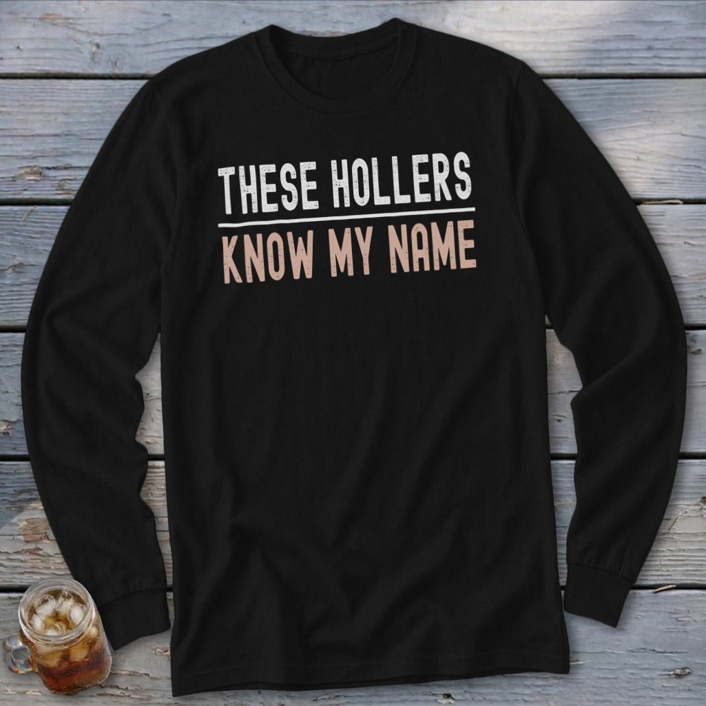 Black long-sleeve shirt with text "THESE HOLLERS KNOW MY NAME".