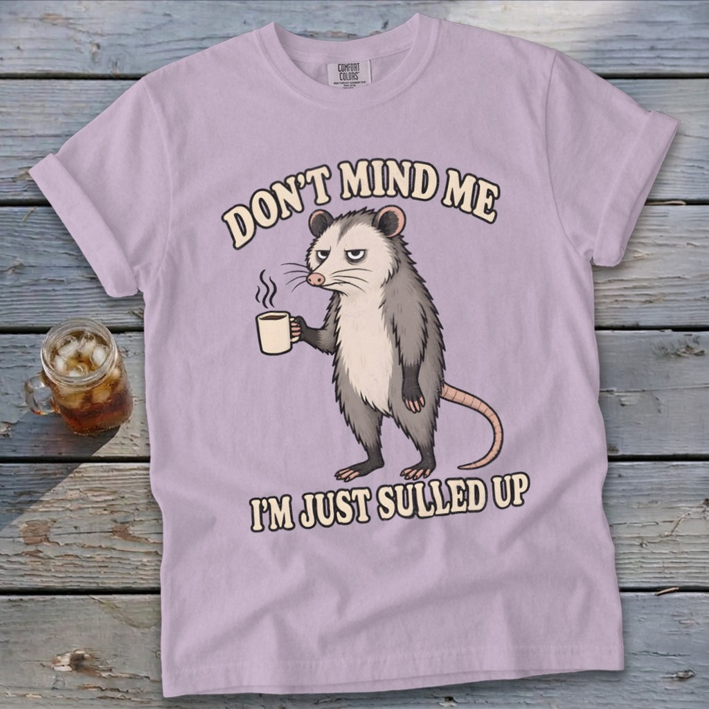 Light purple t-shirt with opossum holding coffee and text "DON'T MIND ME I'M JUST SULLED UP".