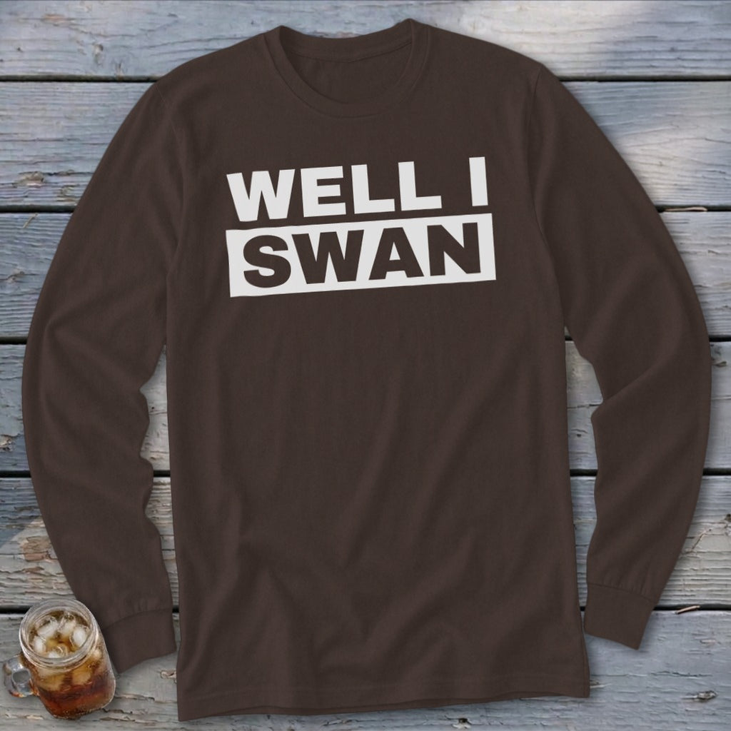 Brown long-sleeved crewneck shirt with white text reading WELL I SWAN on the chest.