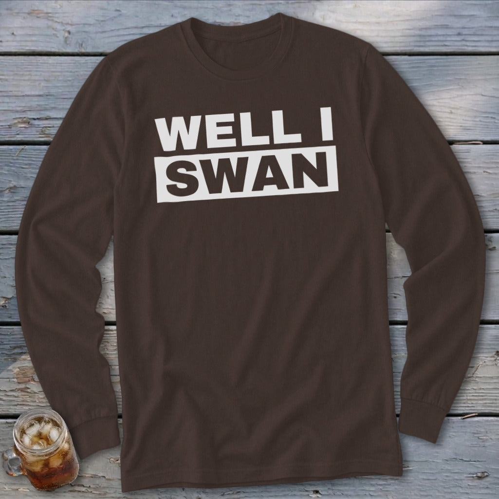 Brown long-sleeved crewneck shirt with white text reading WELL I SWAN on the chest.