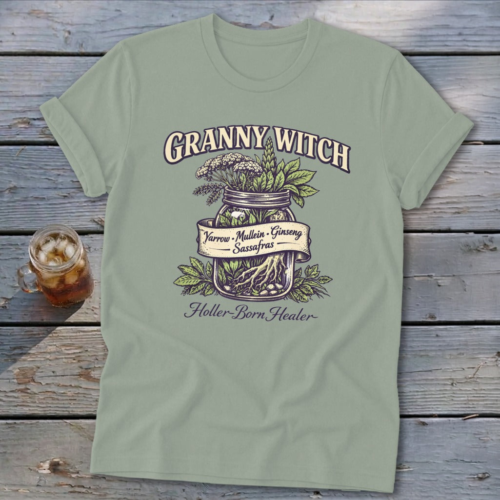 Light green t-shirt with "Granny Witch" and herbs in a jar, listing "Yarrow, Mullein, Ginseng, Sassafras".