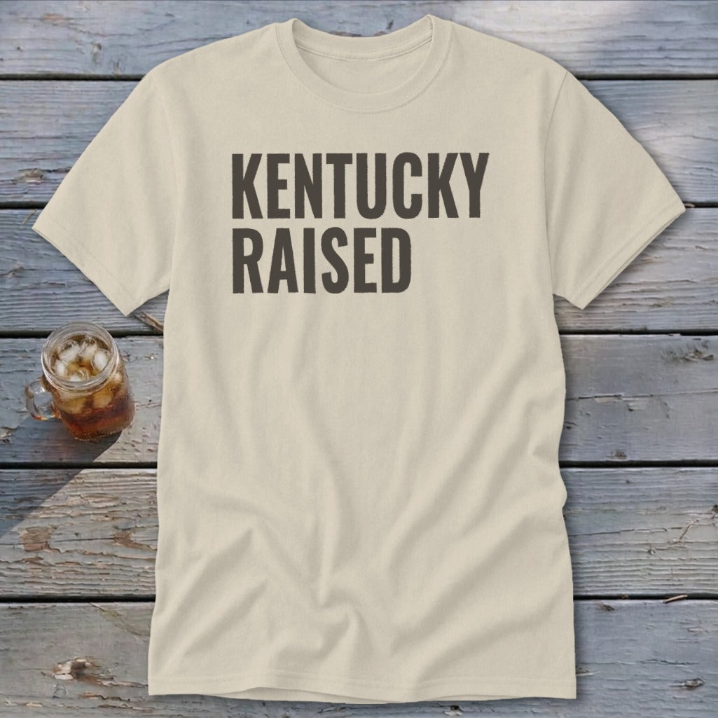 Light beige t-shirt with "KENTUCKY RAISED" printed in dark gray.