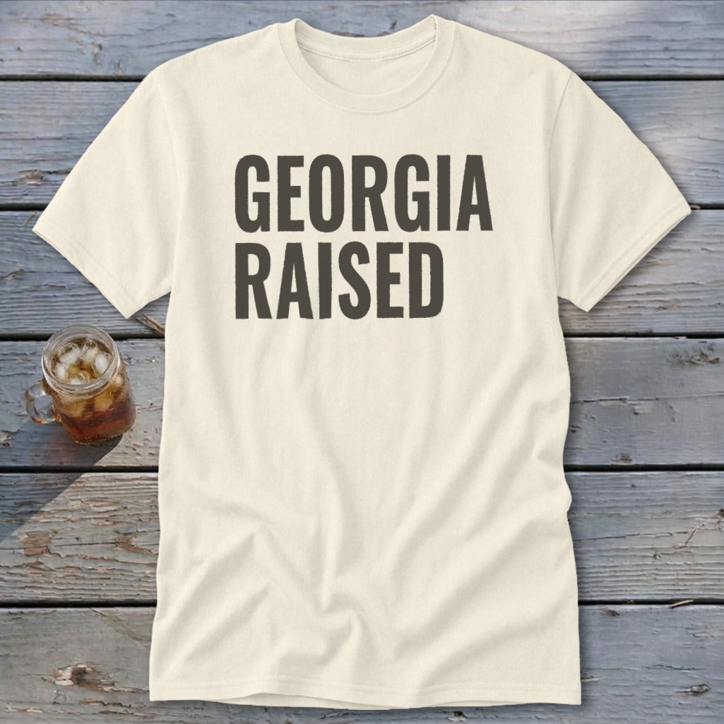 Cream t-shirt with bold black text "GEORGIA RAISED"