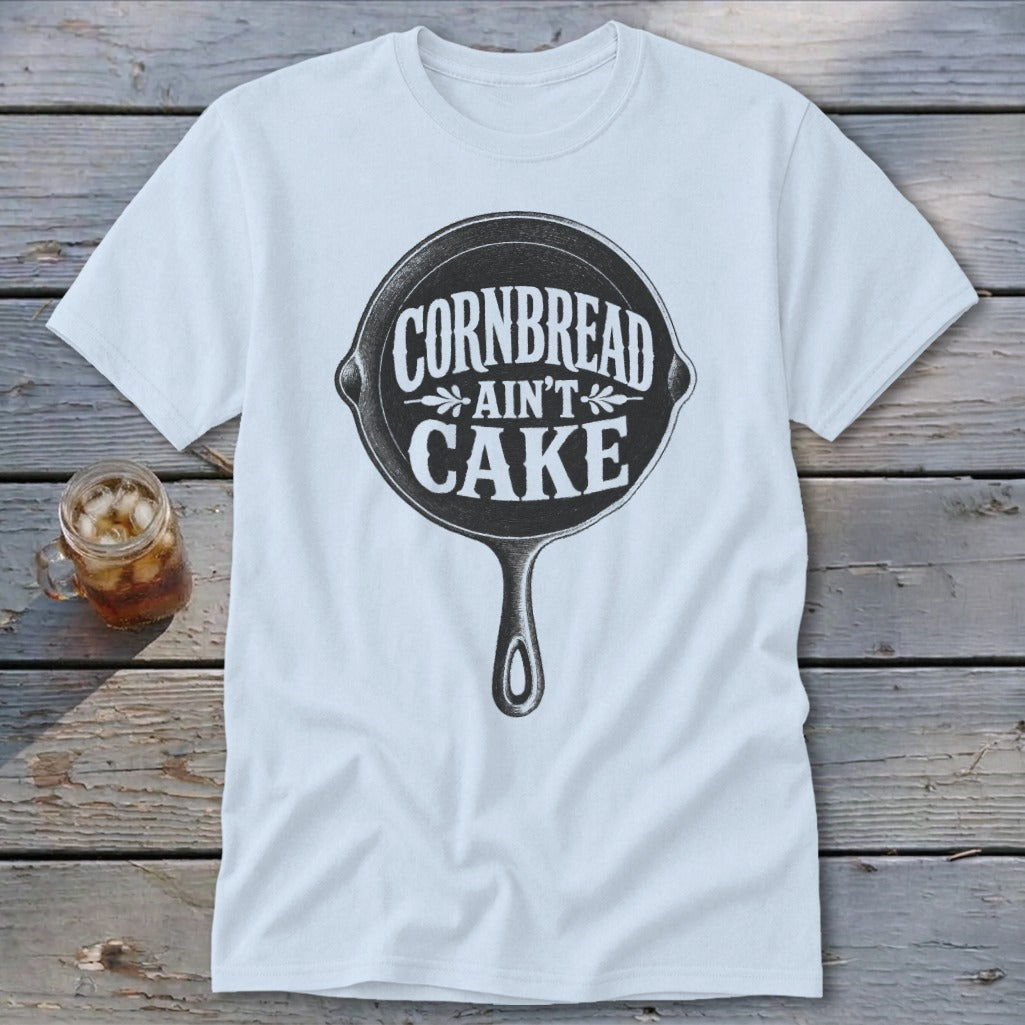 White t-shirt with a cast iron skillet graphic reading "Cornbread Ain't Cake."