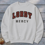 White sweatshirt with "LORDY MERCY" printed in distressed red and black varsity lettering.