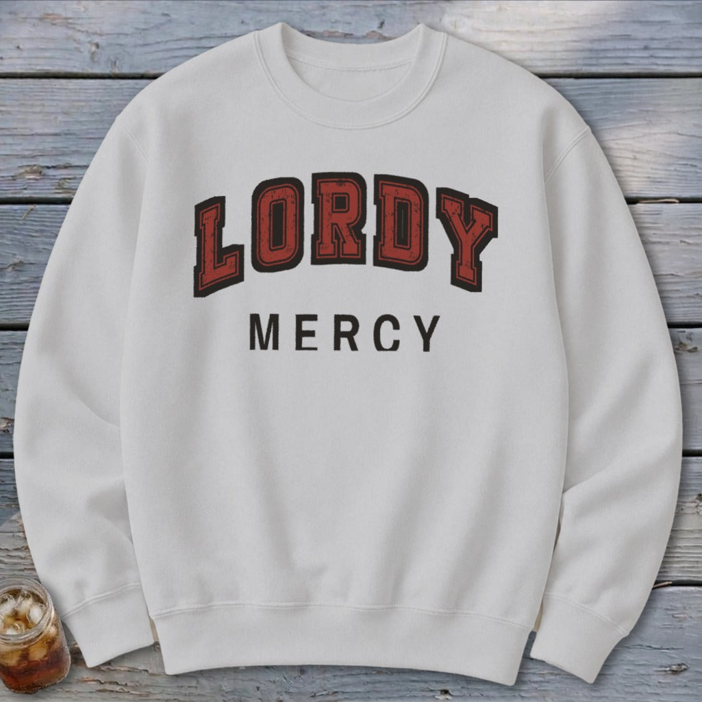 White sweatshirt with "LORDY MERCY" printed in distressed red and black varsity lettering.