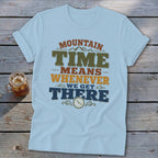 Light blue t-shirt with "MOUNTAIN TIME MEANS WHENEVER WE GET THERE" text and clock graphic.
