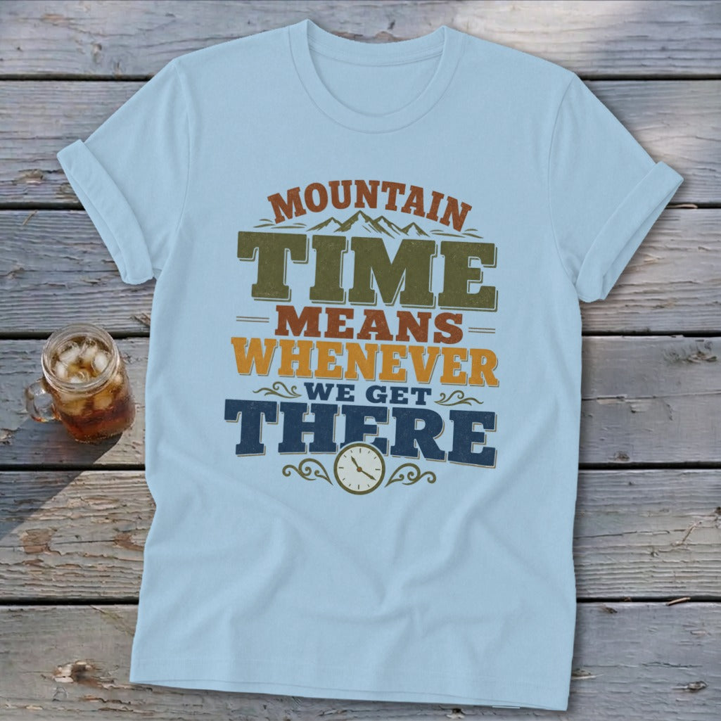 Light blue t-shirt with "MOUNTAIN TIME MEANS WHENEVER WE GET THERE" text and clock graphic.