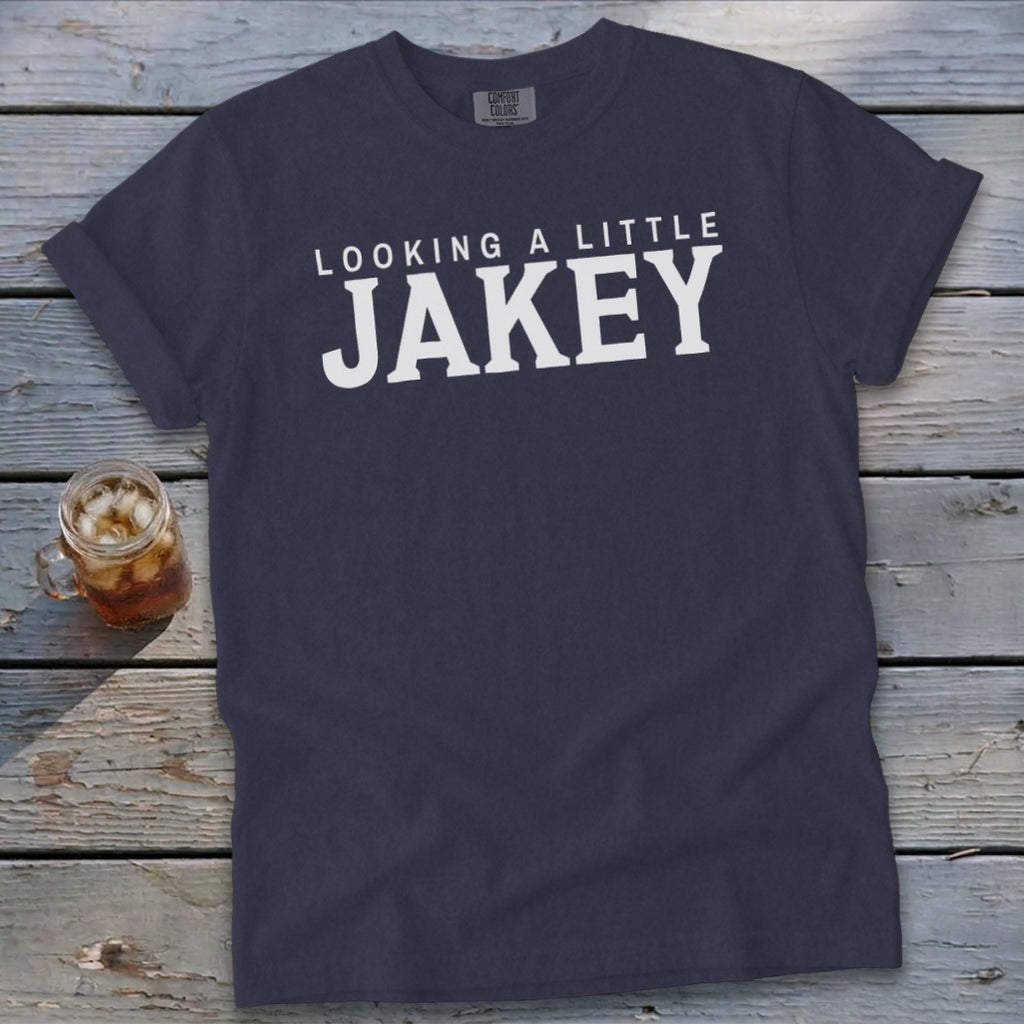 Navy t-shirt with white text "LOOKING A LITTLE JAKEY" and a glass of iced tea.