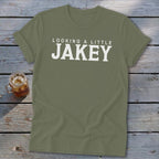 Olive green t-shirt with white text that reads "LOOKING A LITTLE JAKEY".