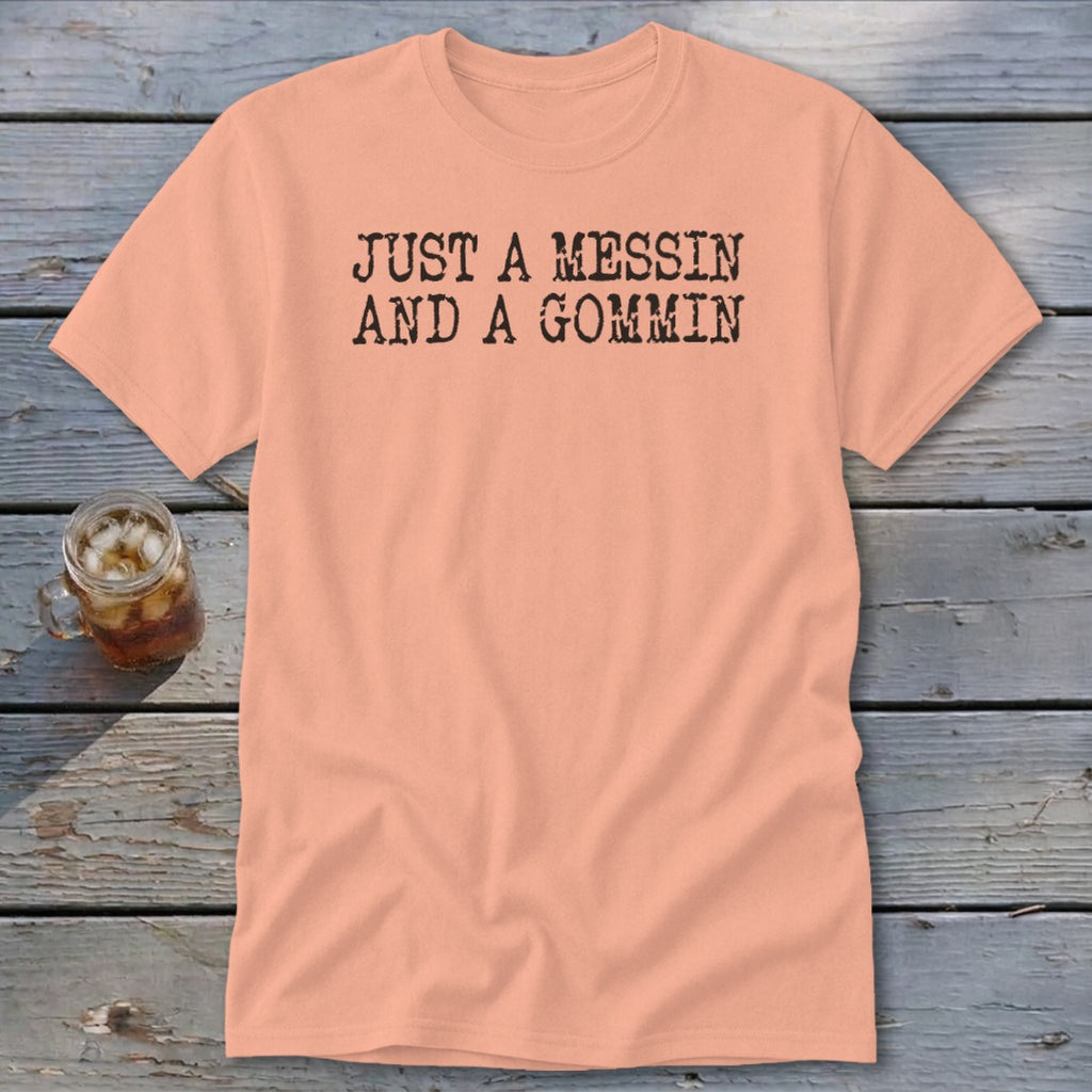 Peach t-shirt with "JUST A MESSIN AND A GOMMIN" printed in black.