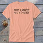 Peach t-shirt with "JUST A MESSIN AND A GOMMIN" printed in black.