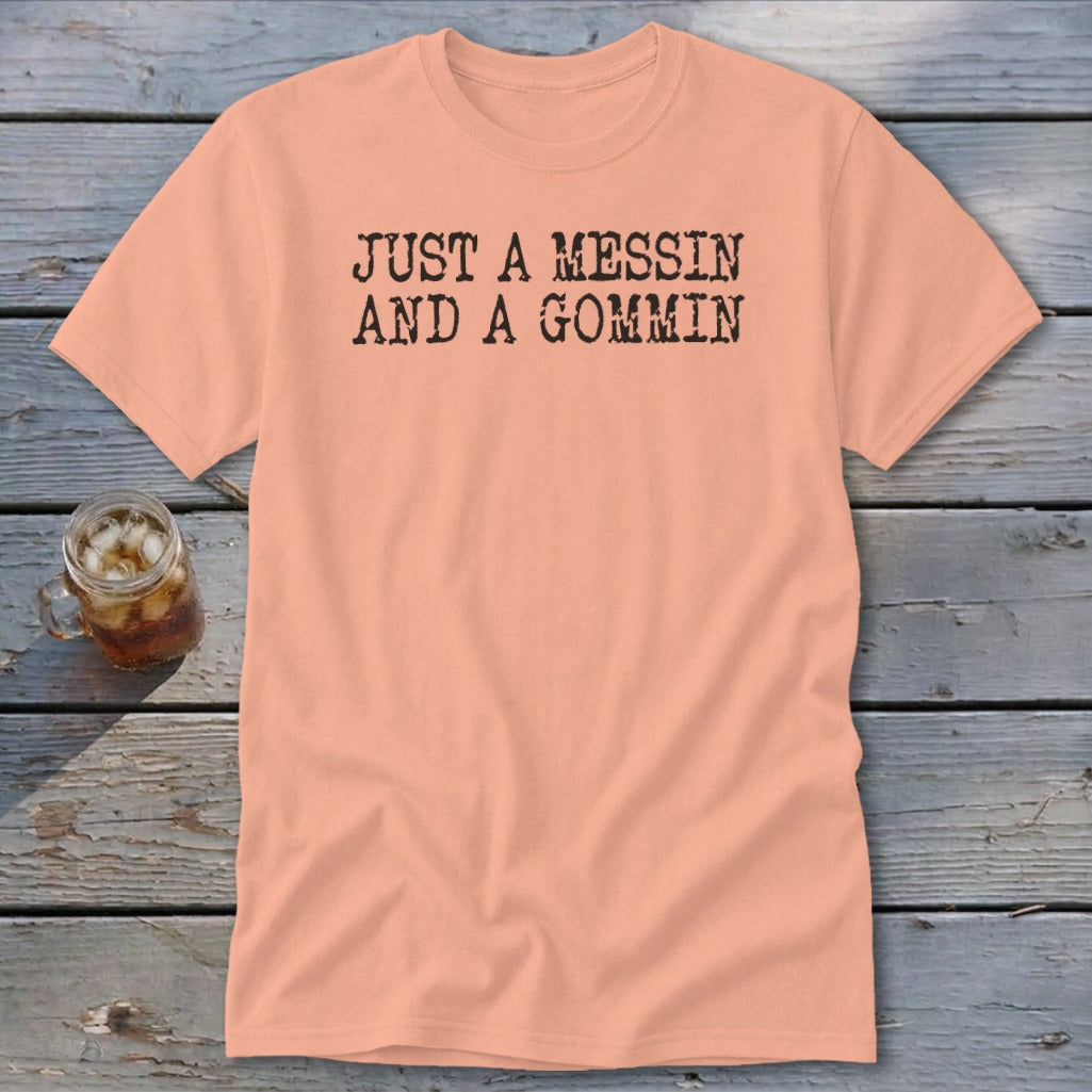 Peach t-shirt with "JUST A MESSIN AND A GOMMIN" printed in black.