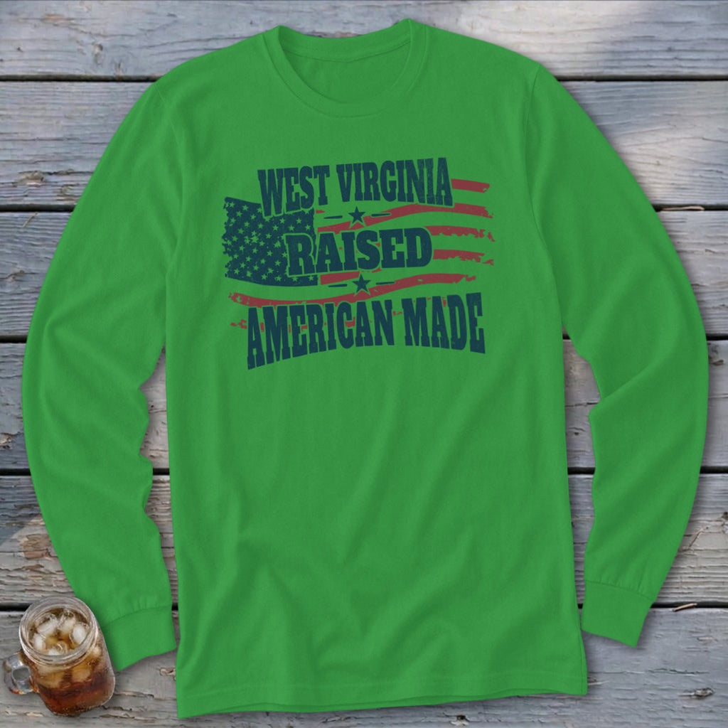 A green long-sleeve t-shirt with blue and red text that reads West Virginia Raised American Made.