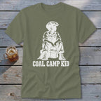 Olive t-shirt with white graphic of a boy holding a bucket, text "COAL CAMP KID".