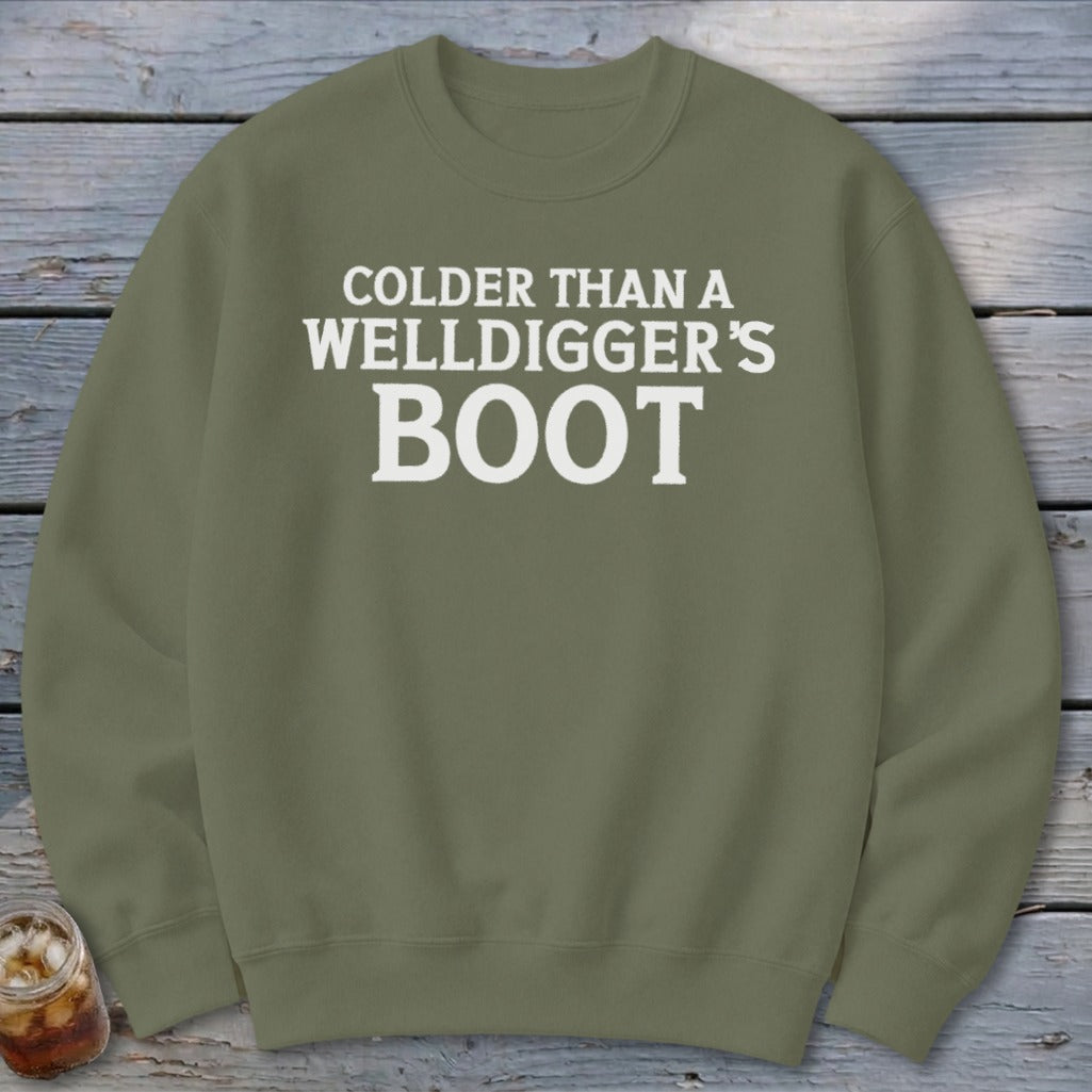 Green sweatshirt with white text reading "Colder Than a Welldigger's Boot".