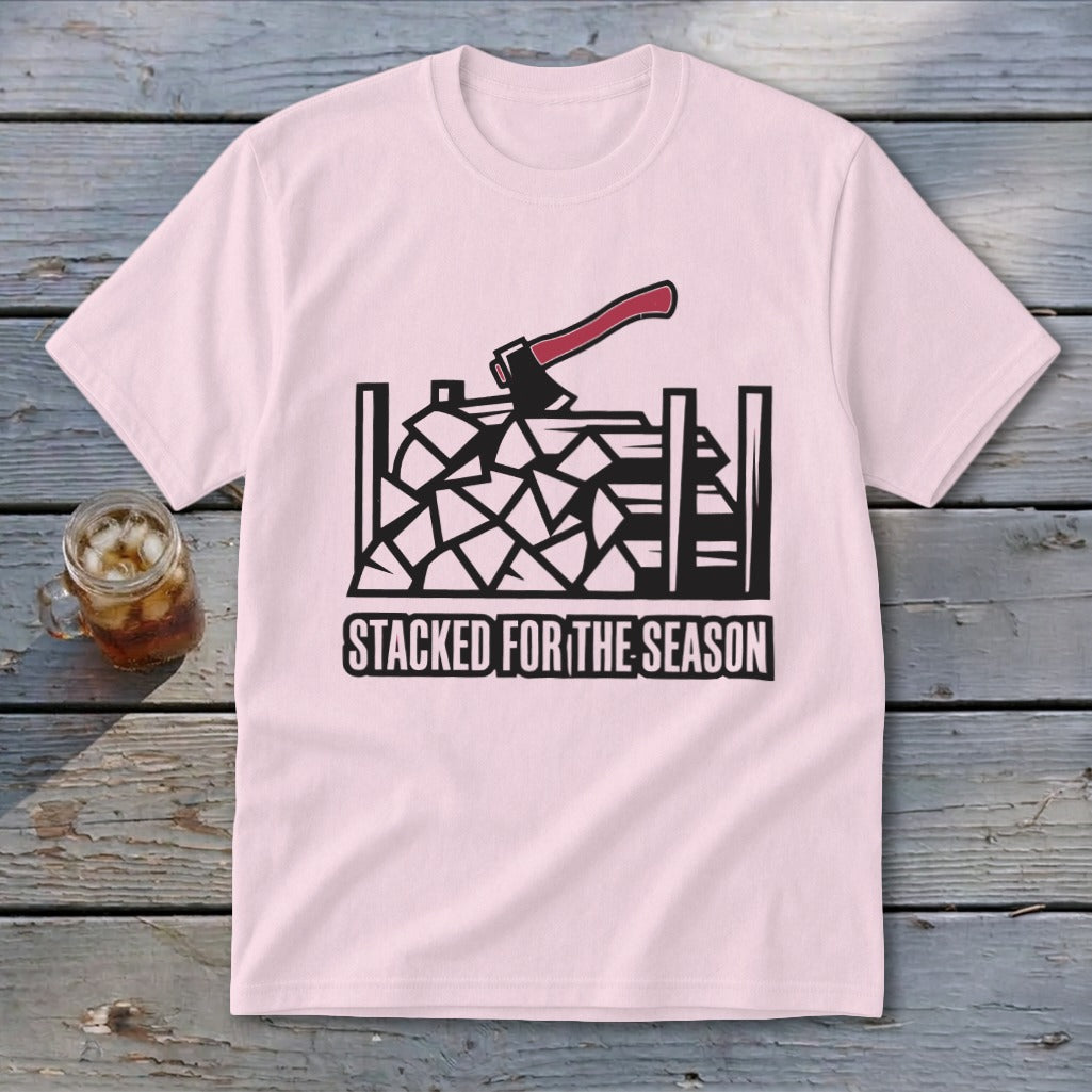 Pink t-shirt with black graphic of stacked firewood and axe, text "STACKED FOR THE SEASON".
