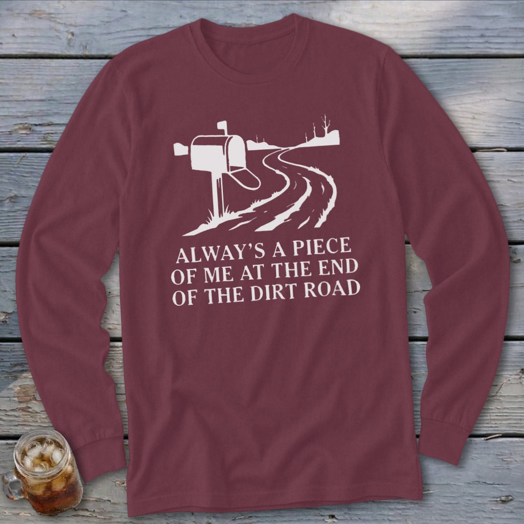 Maroon long-sleeve shirt with white graphic of a mailbox and dirt road, text reads "Always a piece of me at the end of the dirt road."