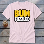 A light pink t-shirt with the words BUM FUZZLED printed in yellow and white on the front.