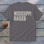 Gray t-shirt with "MISSISSIPPI RAISED" in off-white text.